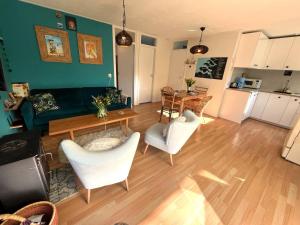 un soggiorno con un divano, un tavolo e delle sedie di Vakantiebungalow Vrijzicht a Kortgene