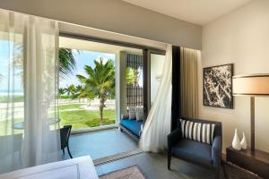a room with a view of the ocean from a hotel room at Anantara Iko Mauritius Resort & Villas in Blue Bay