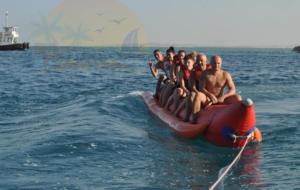 a group of people riding on a raft in the water at Orange Bay in Hurghada