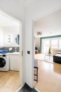 a kitchen and living room with a washer and dryer at Studio Apart - Küche - Balkon - Netflix in Bad Säckingen