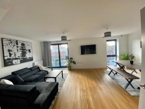 a living room with a couch and a table at Beautiful Penthouse In Bristol - new in Bristol