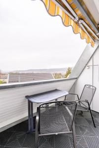 a table and two chairs on a balcony at Studio Apart - Küche - Balkon - Netflix in Bad Säckingen
