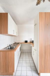a kitchen with white cabinets and a sink at Studio Apart - Küche - Balkon - Netflix in Bad Säckingen