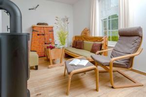 a living room with a wood stove and a couch at Ferienwohnung Storchennest in Neuendorf am See