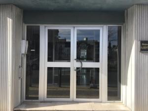 a sliding glass door on the side of a building at FLAT Calais beach in Calais
