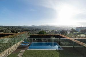 a glass house with a swimming pool and a view at Akivillas Sintra Star in Sintra