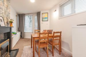 a dining room with a wooden table and chairs at The Corner Stop~ Dog Friendly Holiday Let in Plymouth in Plymouth