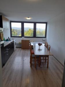 a kitchen and dining room with a table and chairs at Schöne Unterkunft in Lohberg mit Grillplatz und Balkon in Lohberg