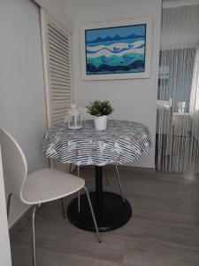 a table with a potted plant on it in a room at Studio Nikola in Baška