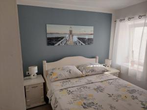 a bedroom with a bed with a picture on the wall at Studio Nikola in Baška