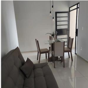 a living room with a couch and a table and chairs at Lugar para chamar de seu in Teresina +6 photos