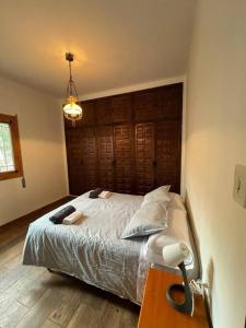 a bedroom with a bed with a wooden headboard at La Casita de Nicolás in Mora de Rubielos