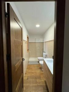a bathroom with a sink and a toilet and a tub at La Casita de Nicolás in Mora de Rubielos