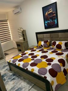 a bedroom with a bed with a cow patterned comforter at Delight Bay Shortlet in Lekki