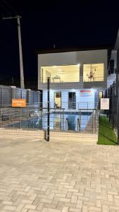 a fence in front of a building at night at Delight Bay Shortlet in Lekki