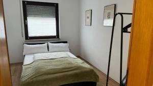 a small bed in a room with a window at Ferienhaus Alexandra in Thyrnau in Thyrnau