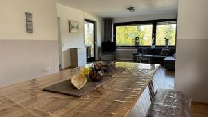 a living room with a table in the middle at Ferienhaus Alexandra in Thyrnau in Thyrnau