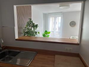a kitchen with a counter and a sink and a mirror at Piso Av Galicia playa in Finisterre +34 photos