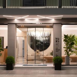 a lobby of a building with a chandelier at 1910 Lifestyle Hotel in Volos