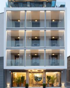 an exterior view of a building with white facade at 1910 Lifestyle Hotel in Volos