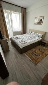 a bedroom with a bed and a rug on the floor at Mamaia Apartments Summerland Club in Mamaia