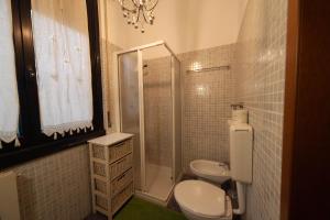 a bathroom with a toilet and a shower and a sink at Antica Corte Milanese in Novate Milanese