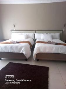 Ένα ή περισσότερα κρεβάτια σε δωμάτιο στο ZWIZWO Guest House