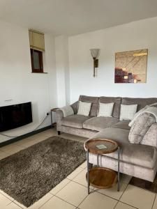 a living room with a couch and a table at The Hay Suite in Aberystwyth