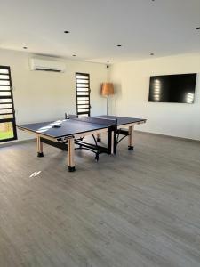 a ping pong table in the middle of a room at Serena Village Tulear in Toliara