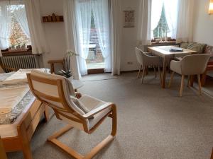 a living room with a chair and a table at Ferienhaus Rotzinger in Hinterzarten