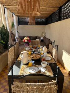 a dining room table with food on it at Riad rénové en 2023, idéalement situé, 5 minutes de la place Jemaa El Fna in Marrakesh