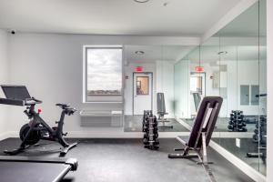 a gym with treadmills and exercise bikes in a room at Jersey City 3br w elevator roof gym nr path NYC-811 in Jersey City