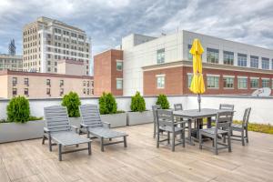 a patio with a table and chairs and an umbrella at Jersey City 3br w elevator roof gym nr path NYC-811 in Jersey City