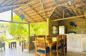 a kitchen and dining room with a table and chairs at Winterthorn Lodge in Chiawa