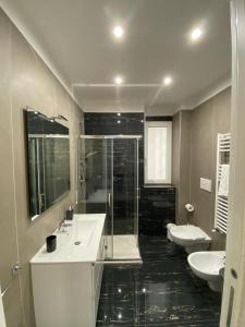 a bathroom with two sinks and a shower at Ennio Rooms in Bari