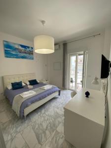 a bedroom with a bed and a desk in it at Ennio Rooms in Bari