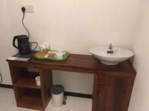 a bathroom with a wooden table with a sink at Ella Panorama Villa in Ella