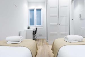 Łóżko lub łóżka w pokoju w obiekcie Egona - Zi28 Centro de Zarautz, Reformada-Luminosa