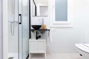 a white bathroom with a sink and a shower at Egona - Zi28 Centro de Zarautz, Reformada-Luminosa in Zarautz