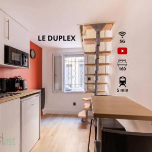 a kitchen with a spiral staircase in a room at Duplex-Université in Lyon
