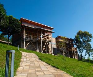a building on a hill with a walkway at Umutuzo lodge Kivu lake 