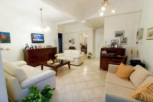 a living room with two couches and a table at Malamatenia Studios in Loutra Edipsou