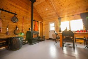 a living room with a stove in a wooden cabin at South McInnes in Red Lake