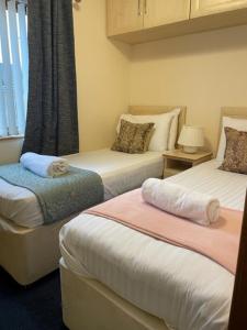 a bedroom with two beds and a window at The Oak Lodge in Aberystwyth