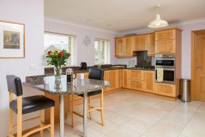 a kitchen with a table with chairs and a counter top at House 23 Ard na Mara in Dingle