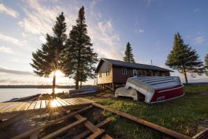 a house with a boat parked in front of it at South McInnes in Red Lake
