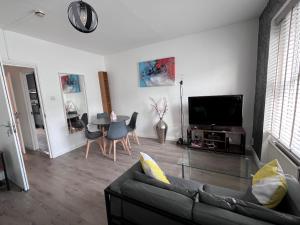 a living room with a couch and a table at Flat in central London with large patio in London
