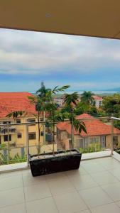 a balcony with a view of palm trees and buildings at Vera's Luxury Home in Munyonyo