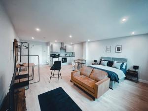 a bedroom with a bed and a couch at Market Haven Deluxe Studios Town centre with Netflix, Business & Leisure Travellers in Northampton
