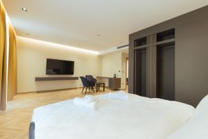 una habitación de hotel con 2 camas y una silla en La Terrazza Hotel & Restaurant, en Hani i Elezit